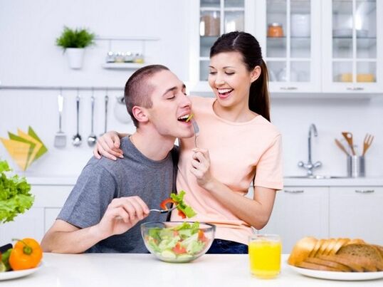 a woman feeds a man with products to naturally increase strength