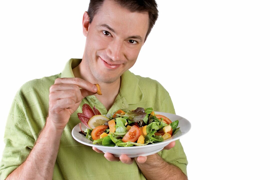 man eats vegetable salad for strength