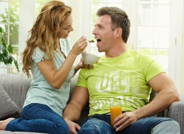a woman feeds a man with products to increase strength